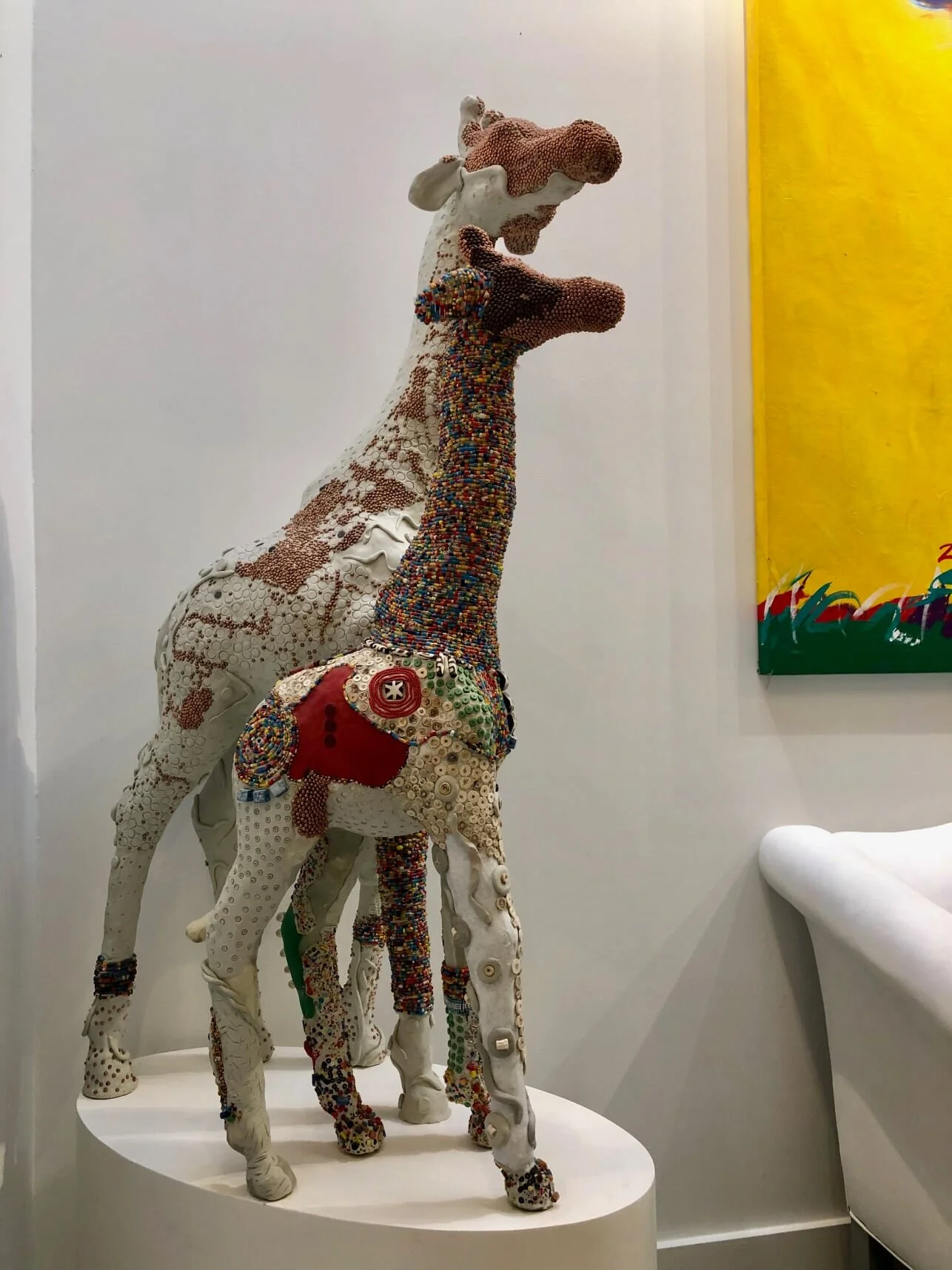 Two embellished giraffe sculptures by Marcie Ziv